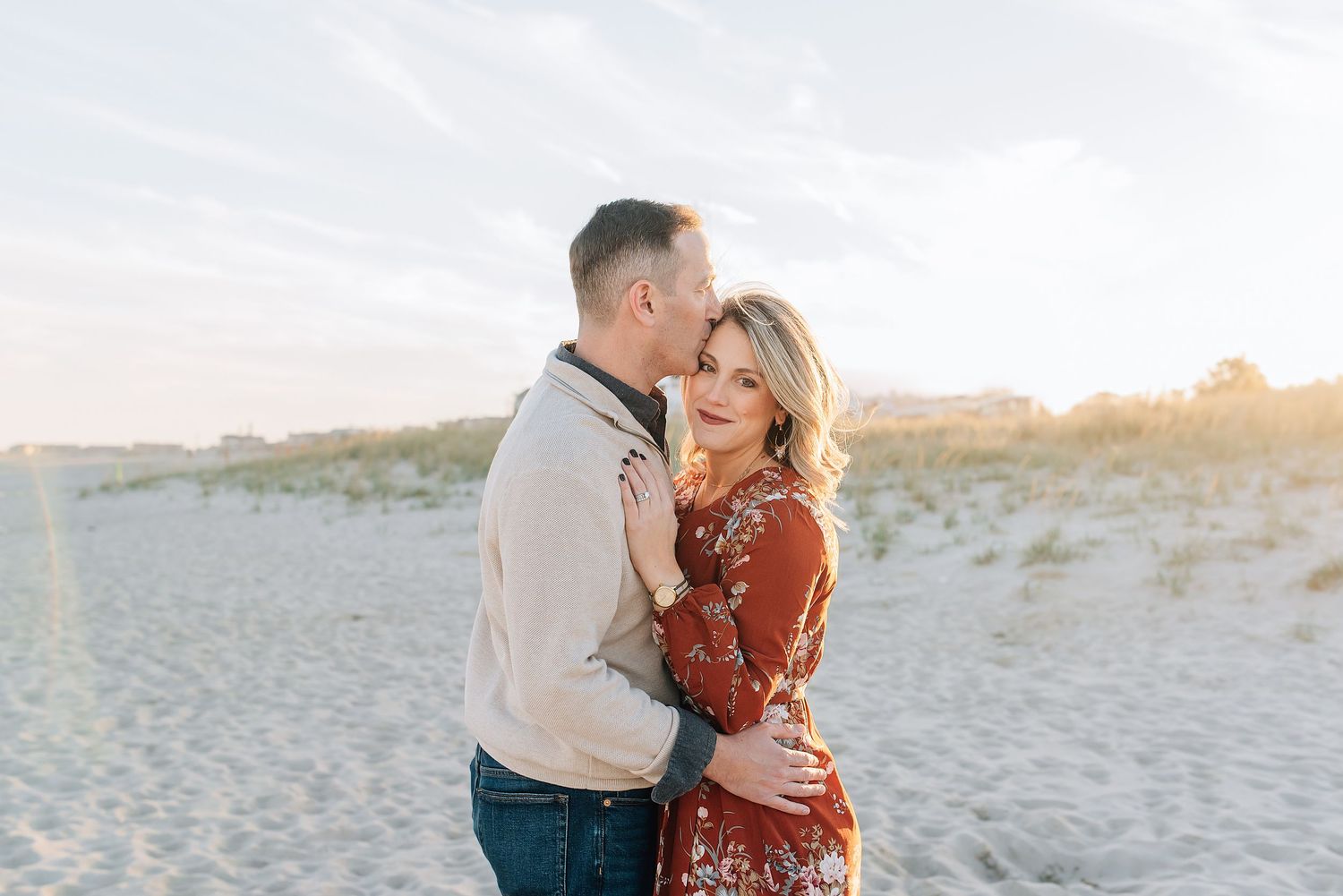 Husband kissing his wife on the forehead during a fall mini session in Monmouth County NJ.
