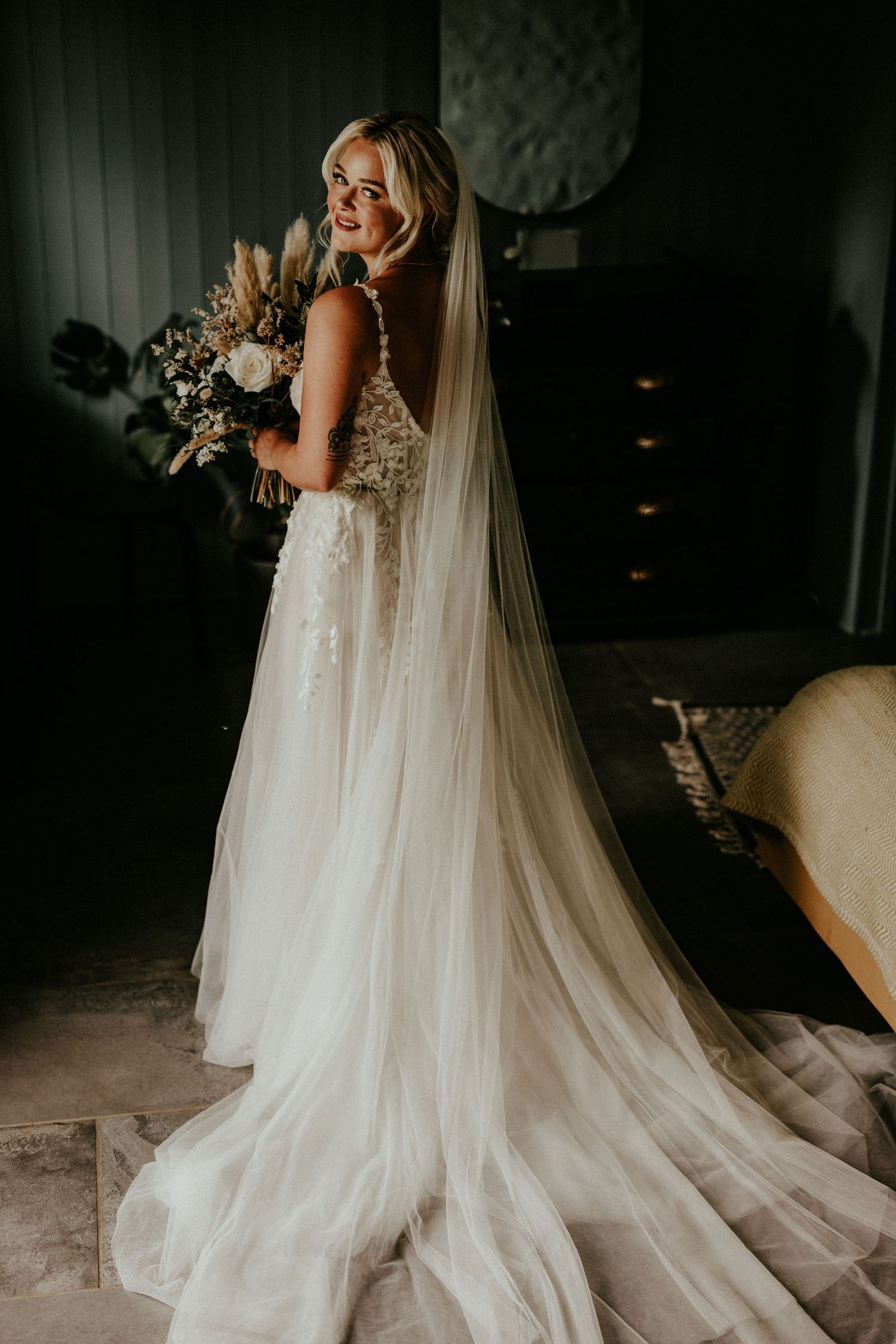 A series of candid moments showing a radiant bride in a flowing lace dress holding a white and dried floral bouquet.