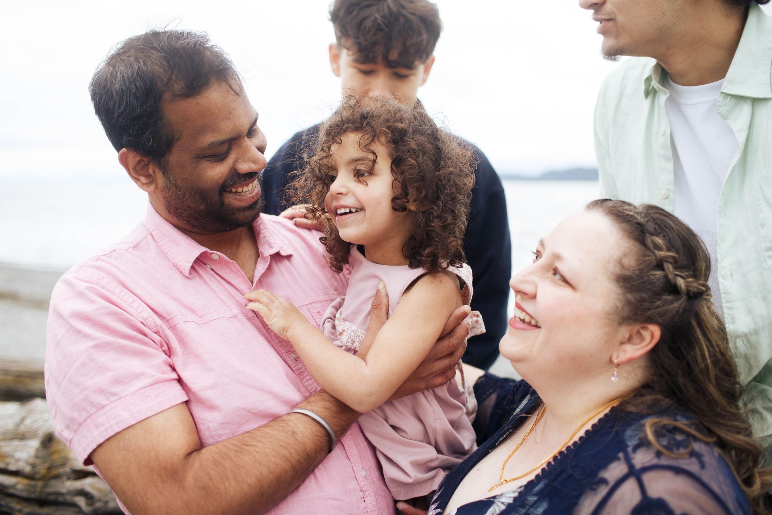 A candid family photo session with a blended family at Mukilteo Lighthouse Park in Mukilteo WA