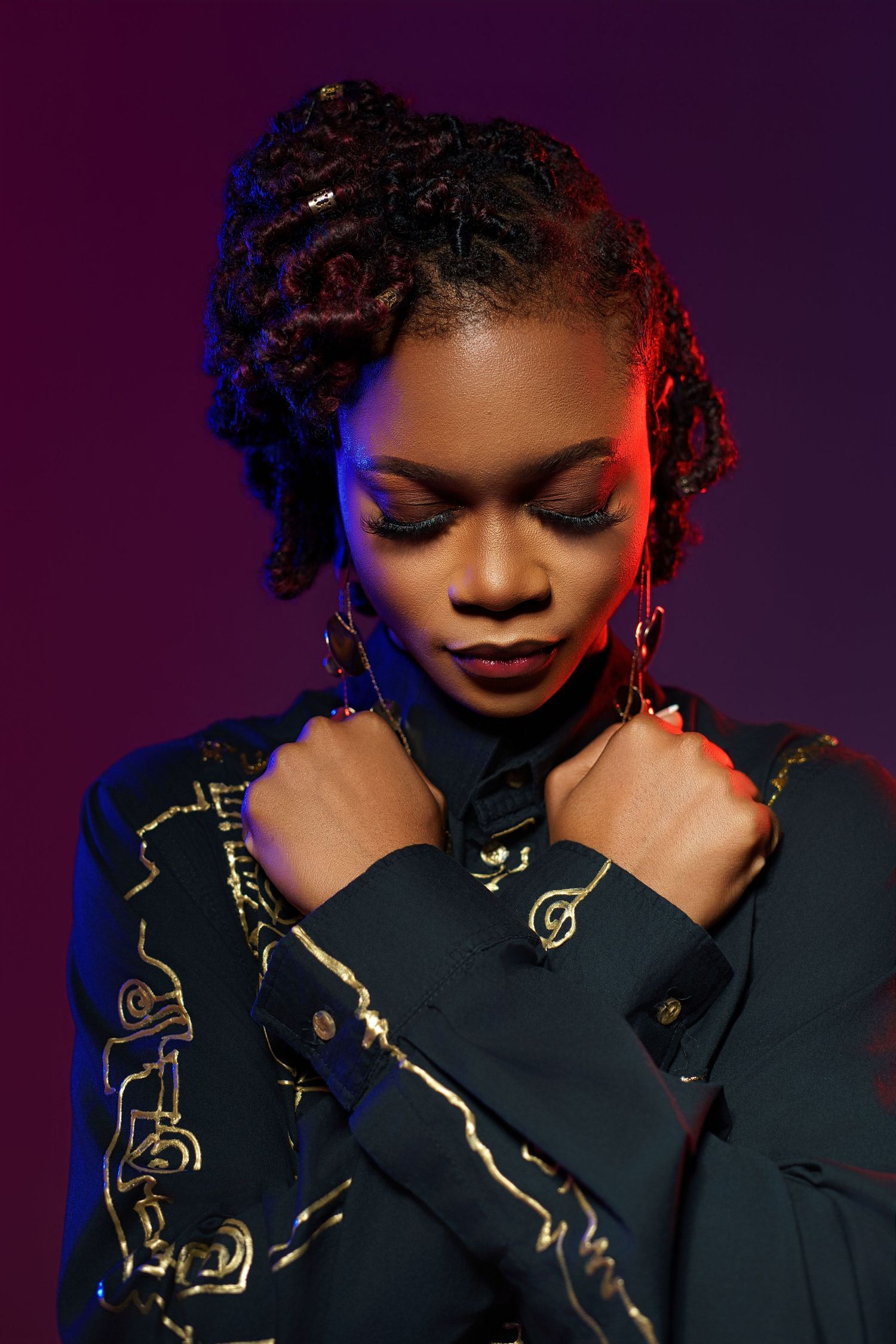 A series of moody fashion portraits with dramatic lighting showing a model in a black outfit against a dark purple background.