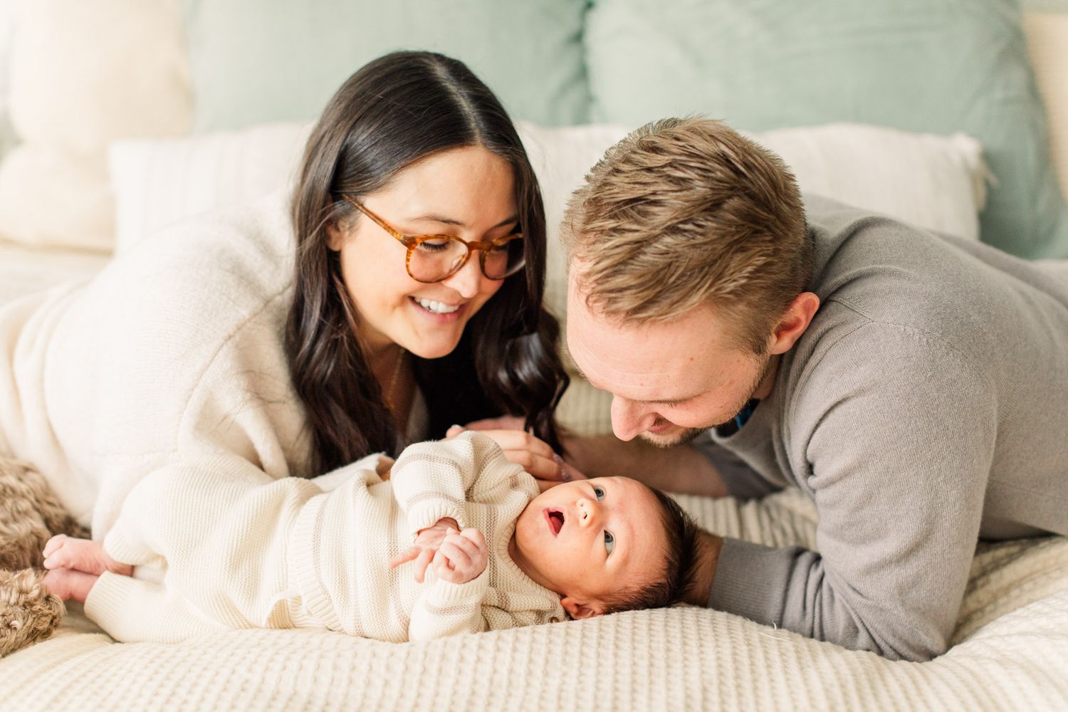 In-home newborn session in Richmond VA with parents snuggling baby