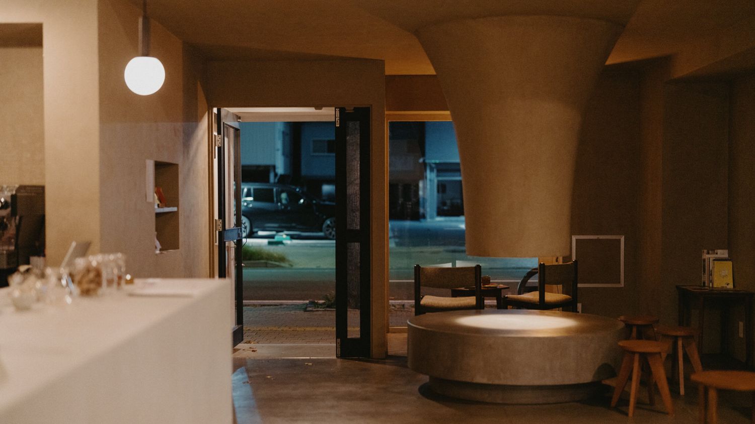 Modern office interior with warm lighting features sleek furniture and glass walls creating an inviting workspace atmosphere.
