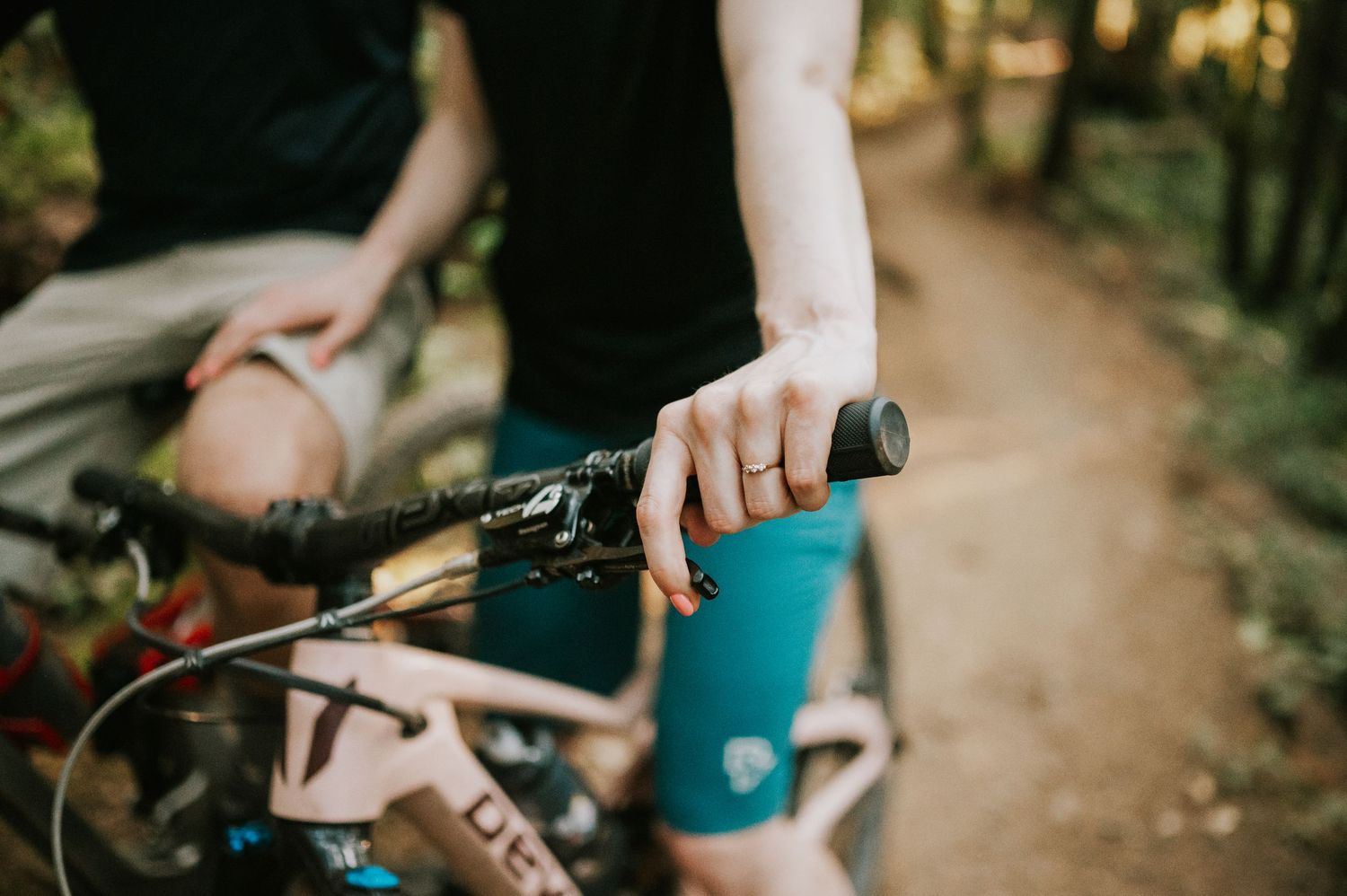 Adventurous couple photographer mountain biking through Cumberland Forest during their Vancouver Island engagement session detail ring shot