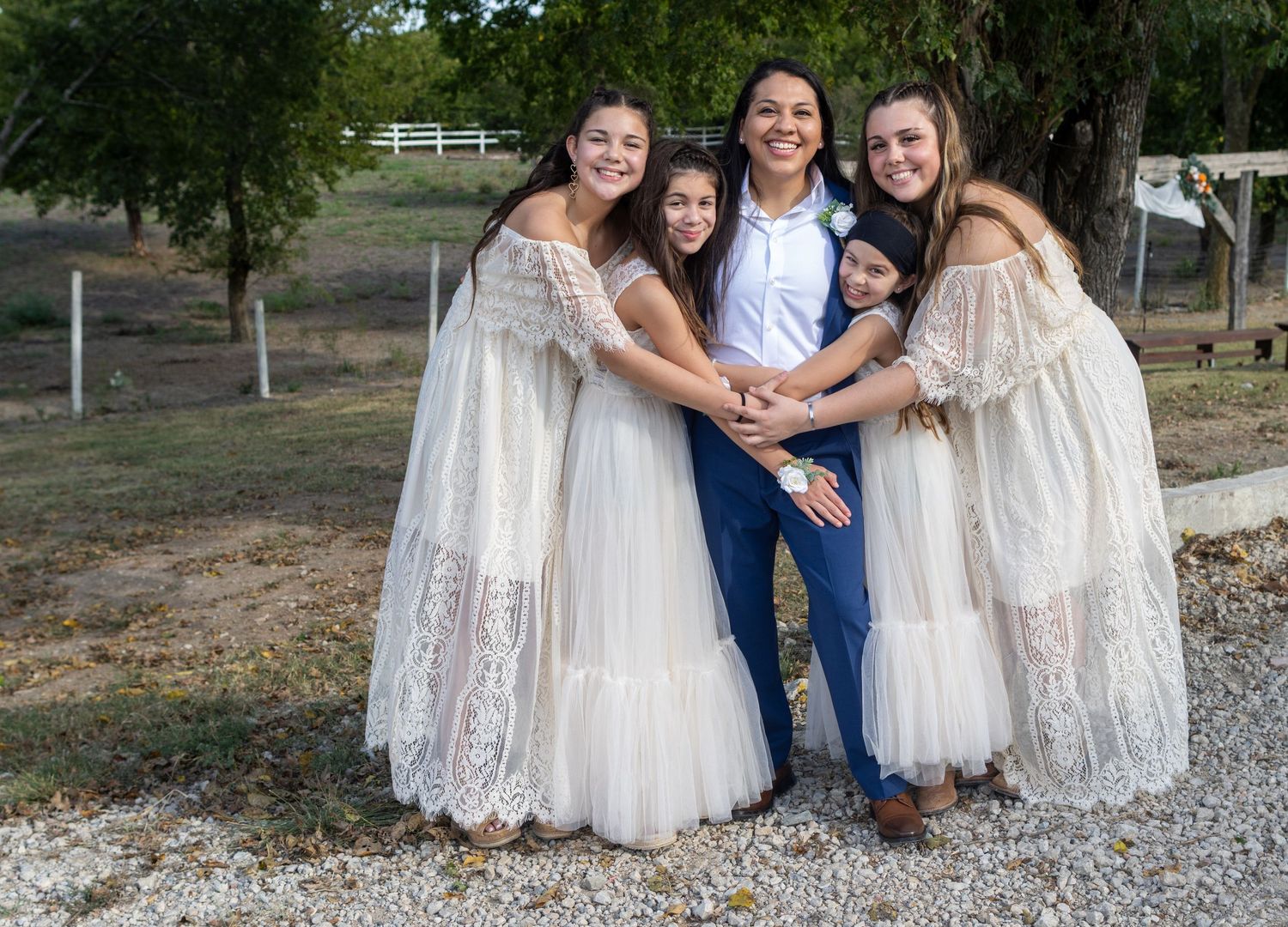 Family group photo session outdoors with white lace dresses.