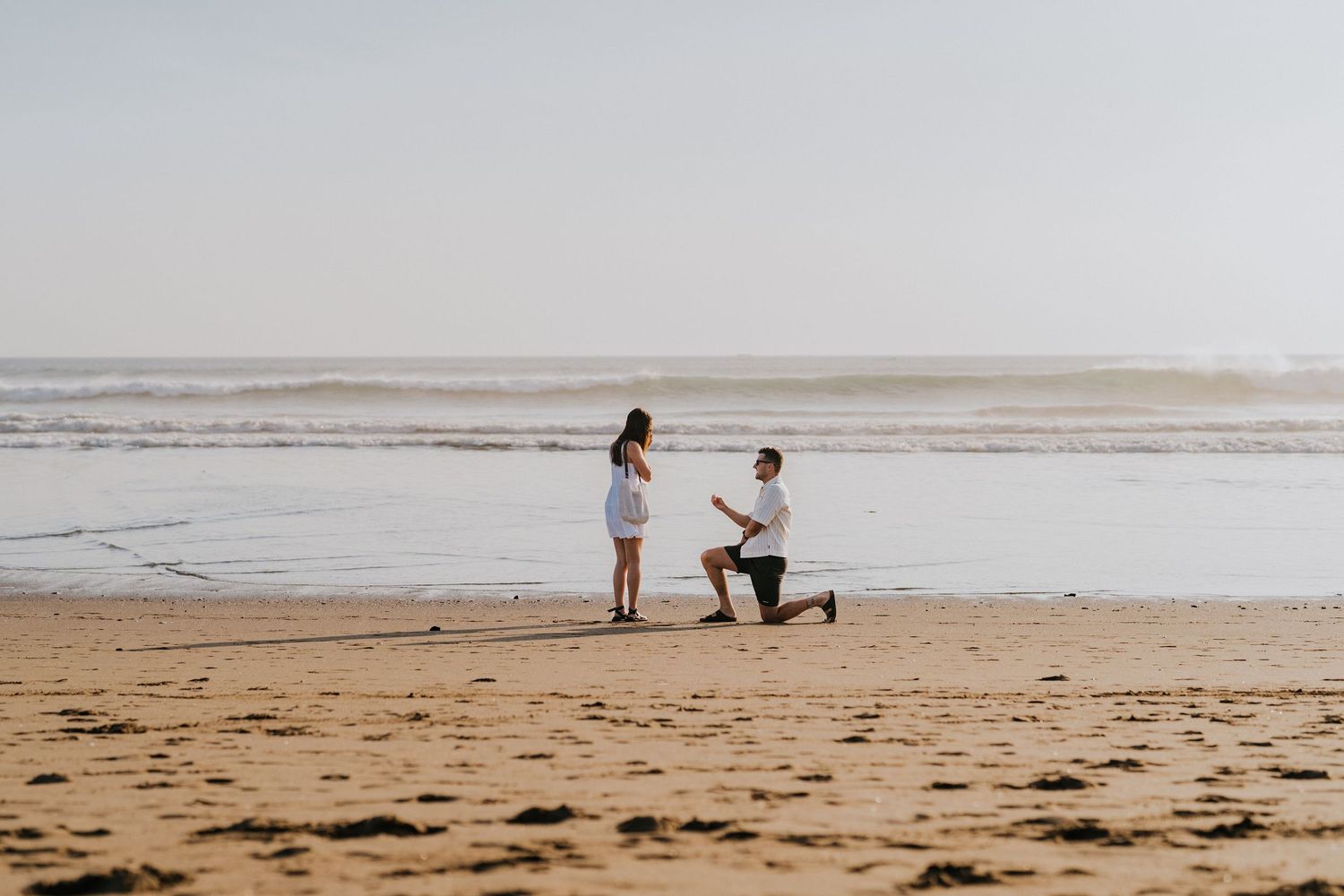 Couple celebrating a proposal on Petitenget Beach