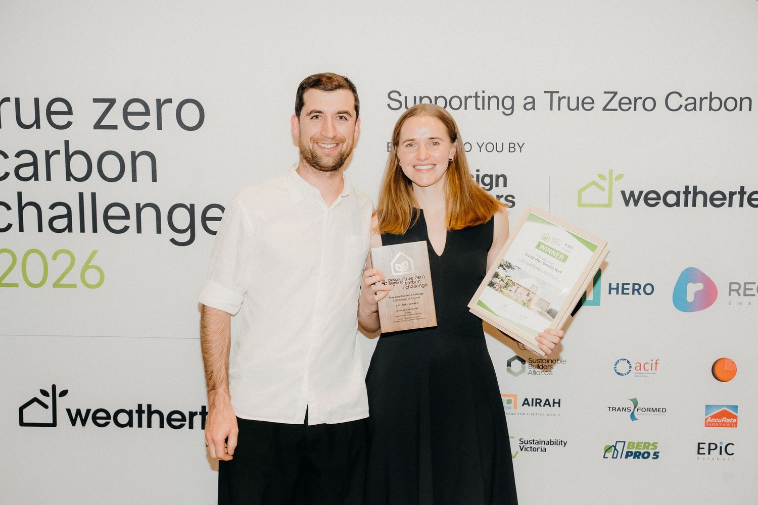 Two award winners pose with certificates at the True Zero Carbon Challenge 2026 event sponsored by Weathertec.