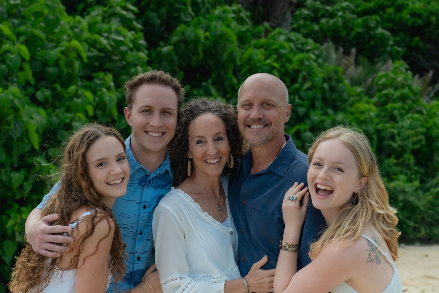 family on waikiki beach posing for a photo