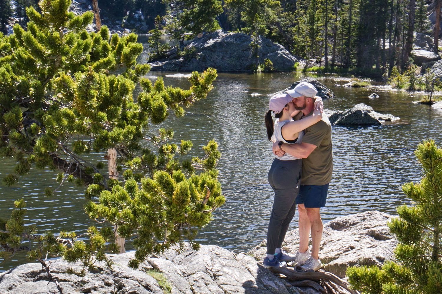 Couple embracing after she said yes to his marriage proposal at Dream Lake. Pixcapades | The Rocky Mountain Proposal Photographer