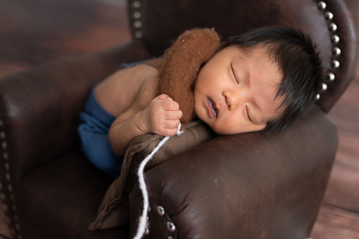Mother and baby during a luxury new born photoshoot Dubai home session with professional lighting and setup.