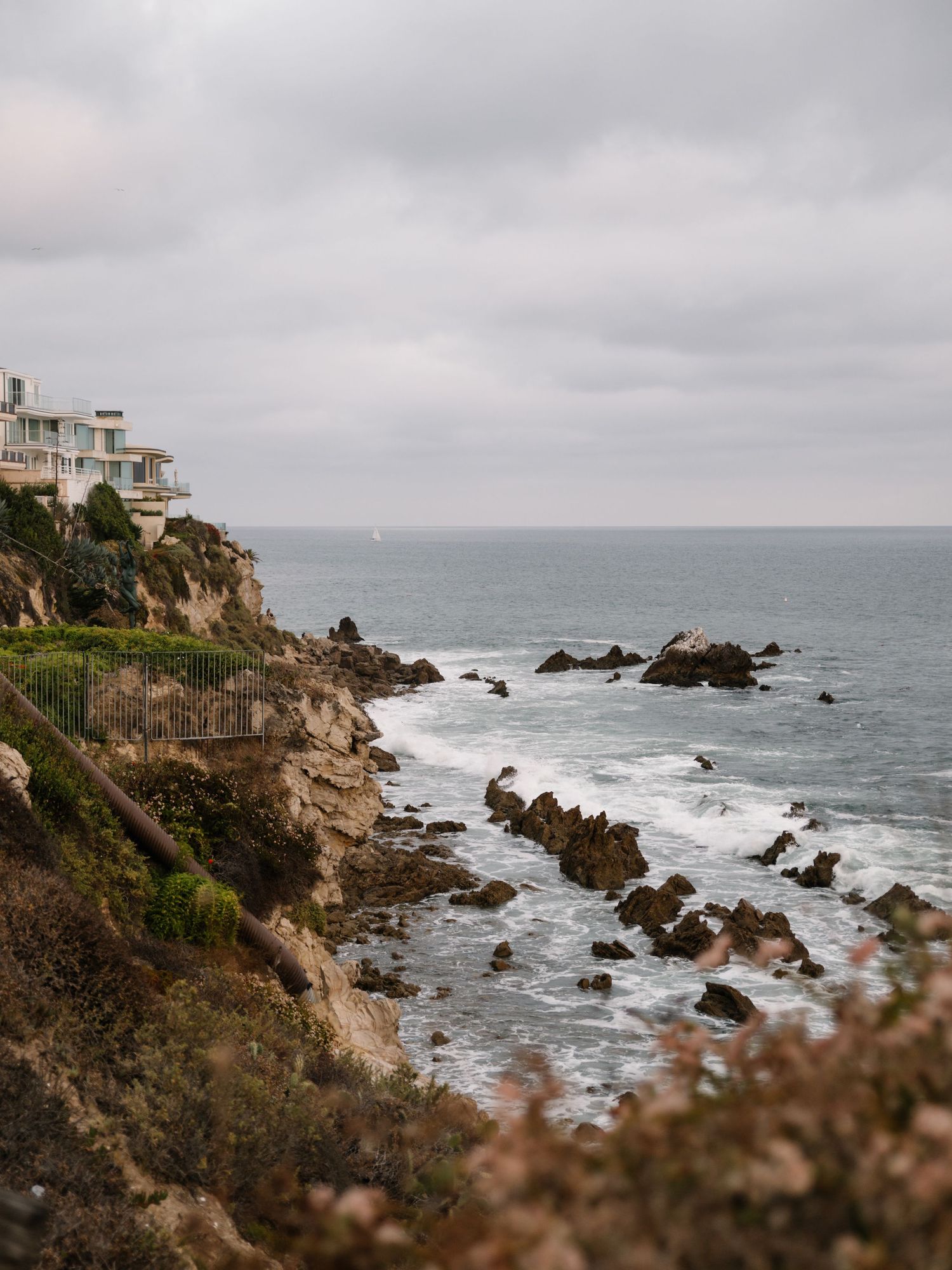 Newport Beach coastline and ocean photographed from above with rocky cliffs and coastal landscape.