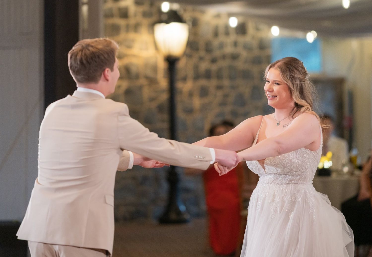Bride and groom smiling during their first dance at Alexandra and Riccardo's wedding reception at The Carriage House At Rocklwood