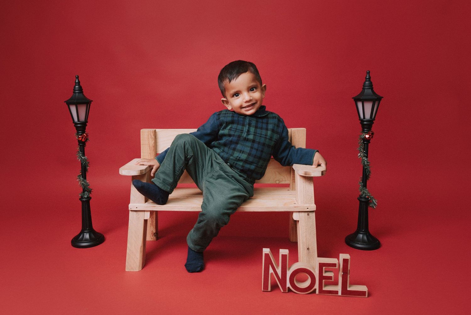 Winter themed portrait session with snowflake decorations and warm earth tone clothing.