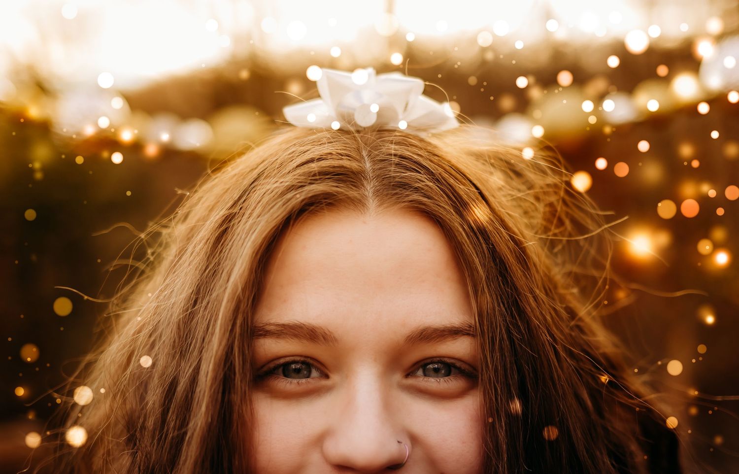 Close up portrait with bokeh lights and sparkles in golden sunset light.