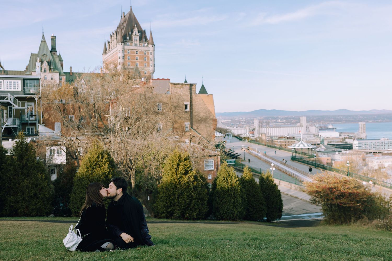 Scenic view of Chateau Frontenac castle and St Lawrence River from hillside garden.