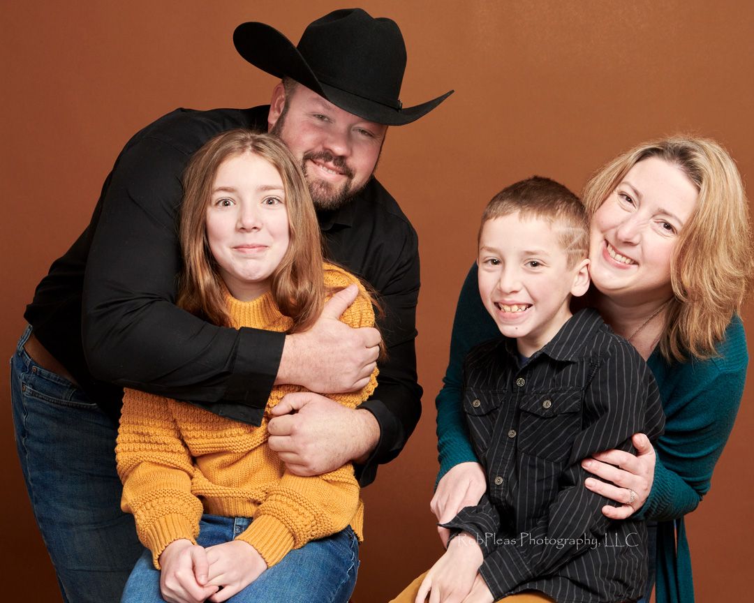 family photo session in studio parents grabbing kids