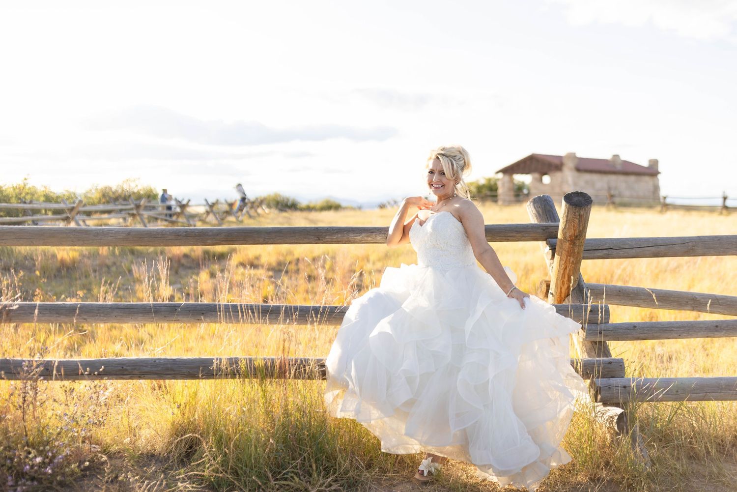 Smiling bride in white dress at sunset, representing Michele McCoy's award-winning photography.