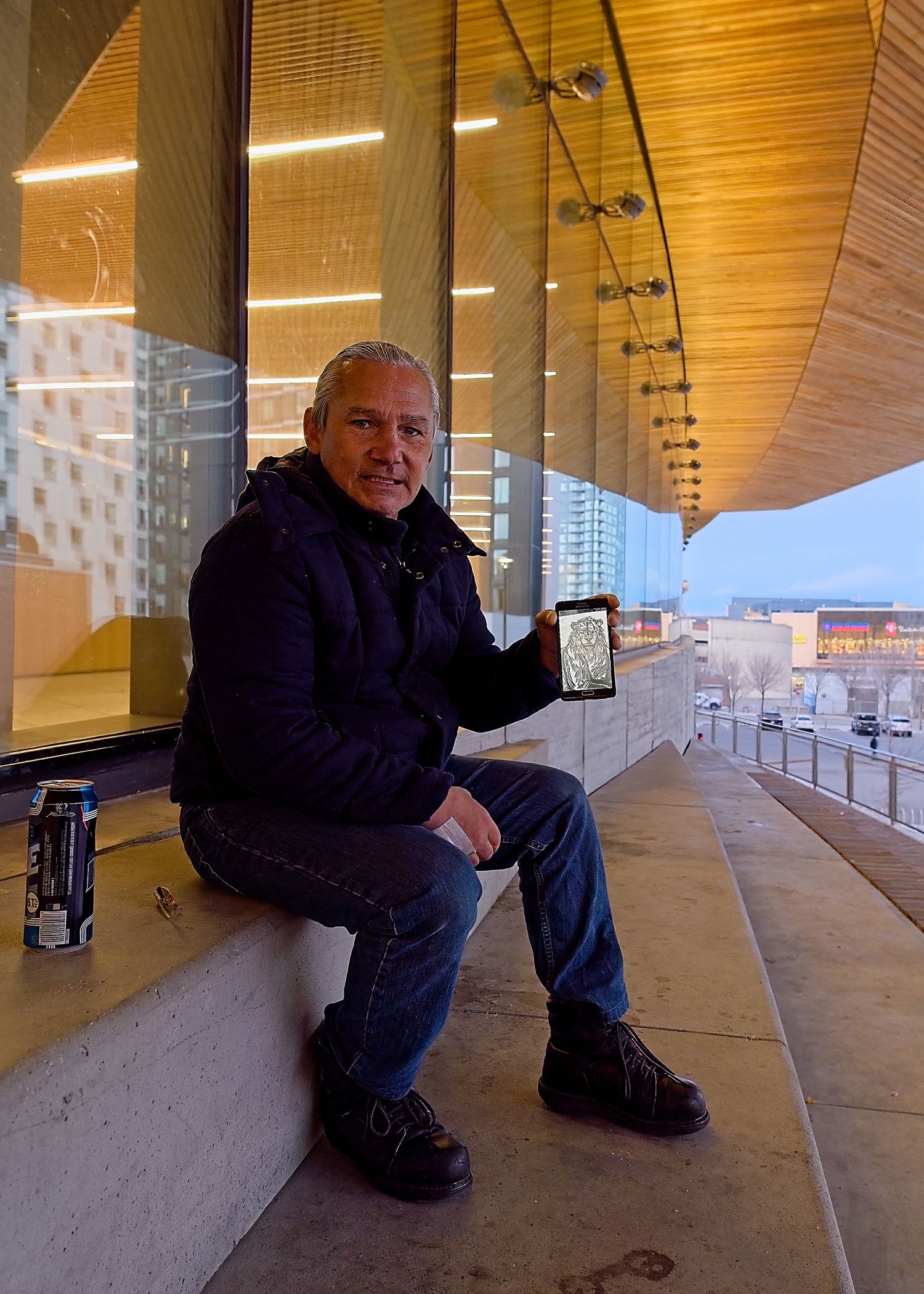 Richard holding up a sketch on his phone