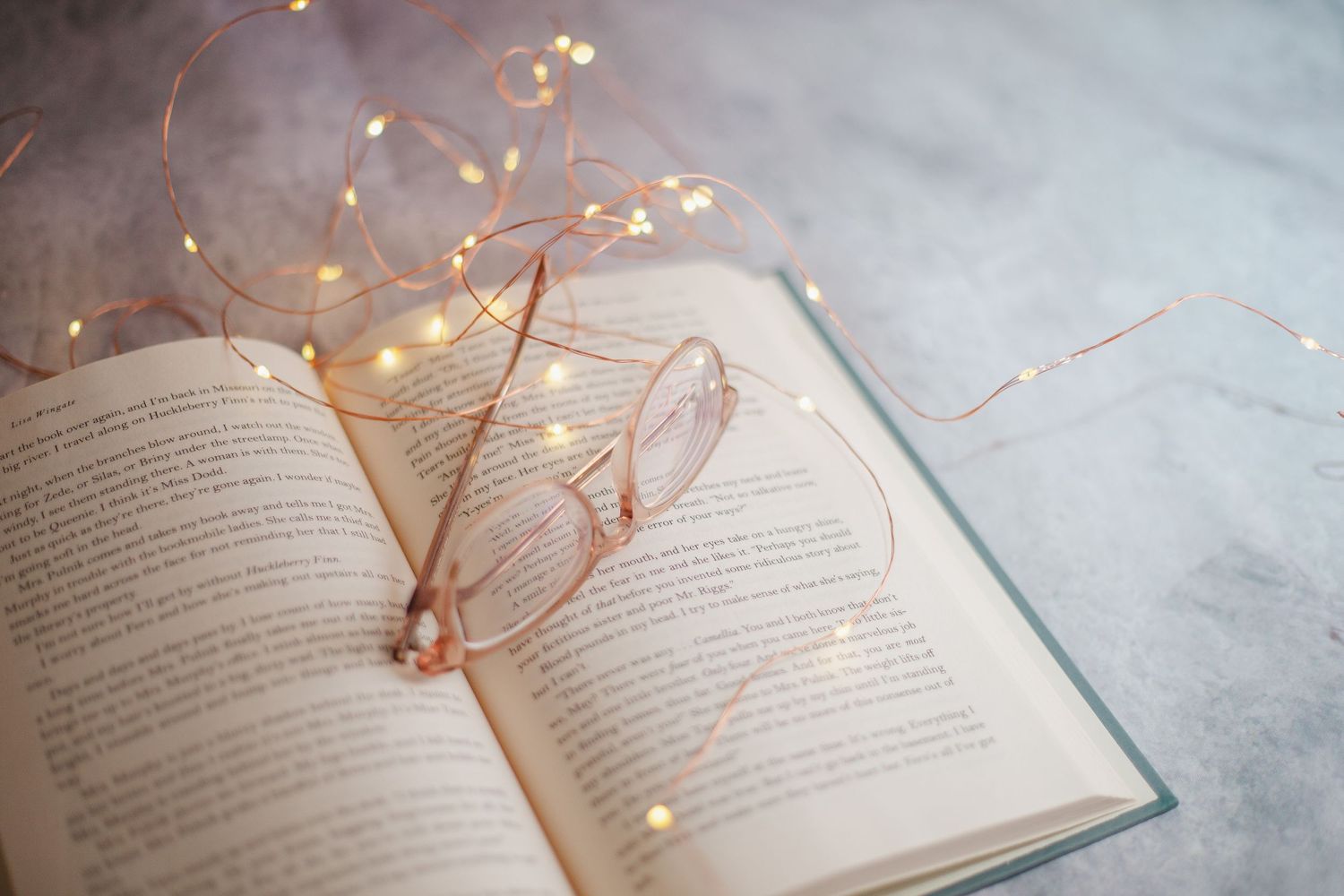 Open book with delicate fairy lights creating a magical reading atmosphere.