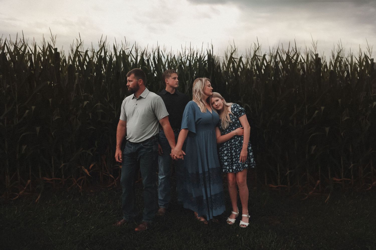 Jade Made Photography of family in Iowa standing by corn rows