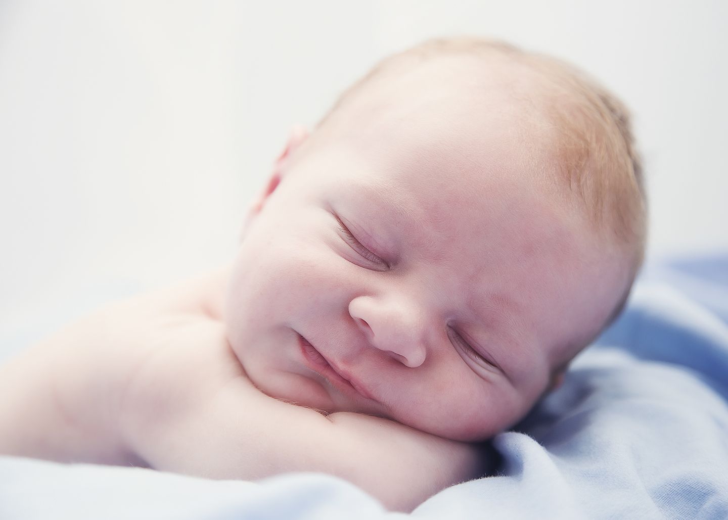 My newborn baby boy sleeping peacefully in the cool clean light