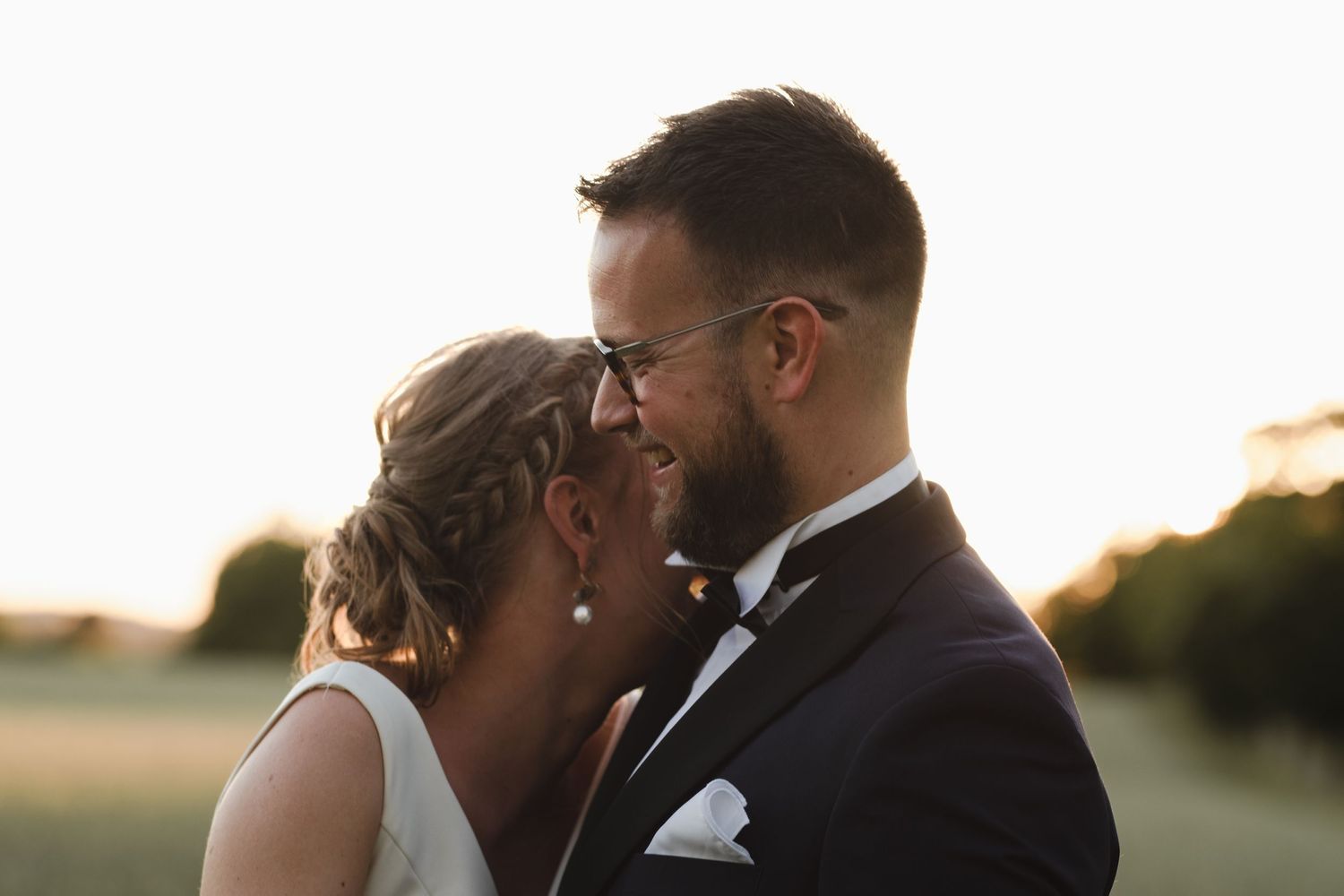 A tender moment between newlyweds during golden hour.