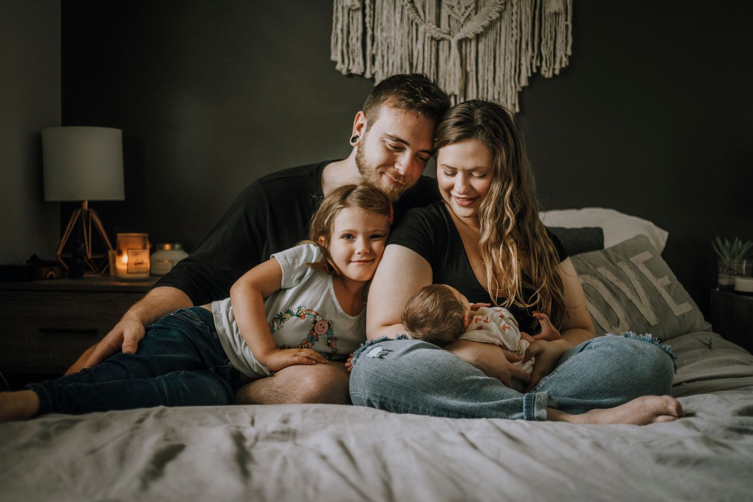 A cozy bedroom scene with a macrame wall hanging and warm lighting.