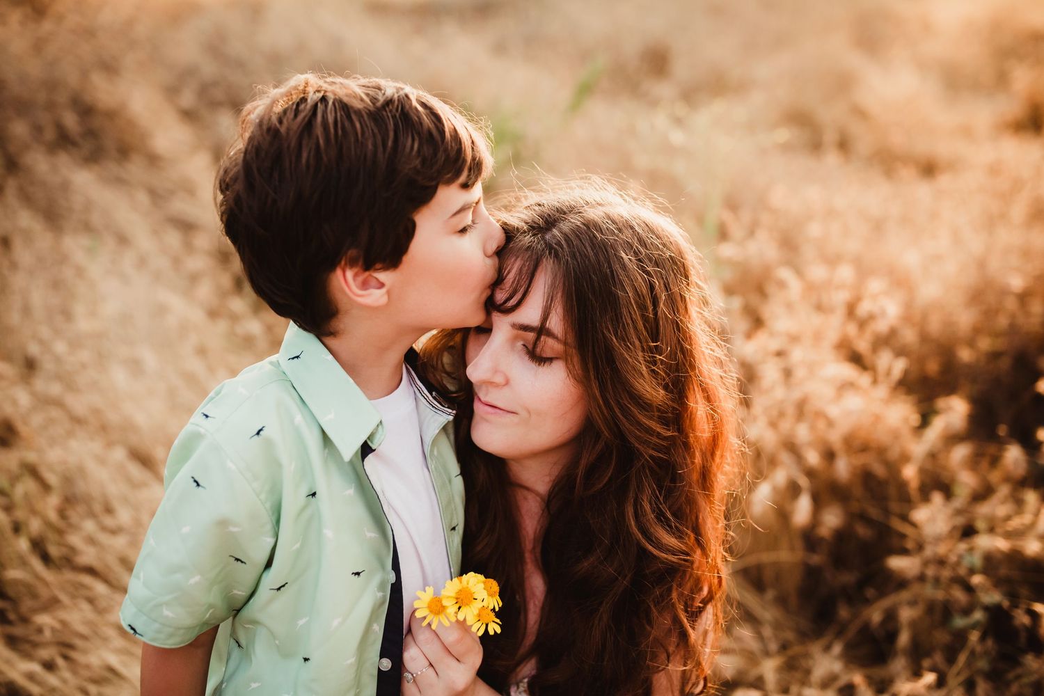 a young boy kisses his mom on the head during a mommy and me photo session in redlands ca