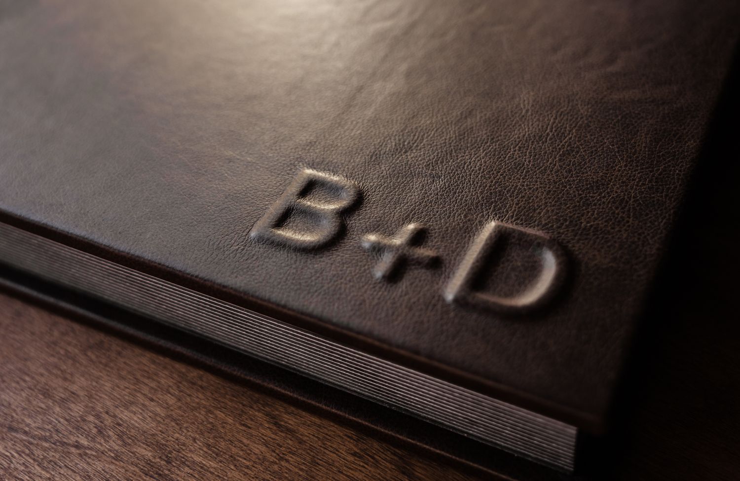 Close-up detail of embossed black leather texture showing subtle patterns and textures.