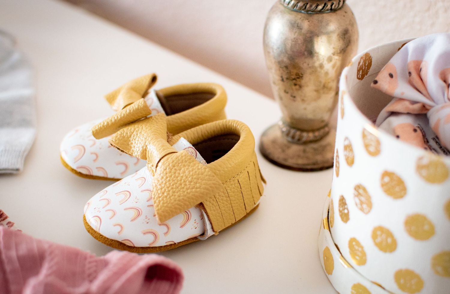 a close-up detail image of a nursery dresser with baby moccasins
