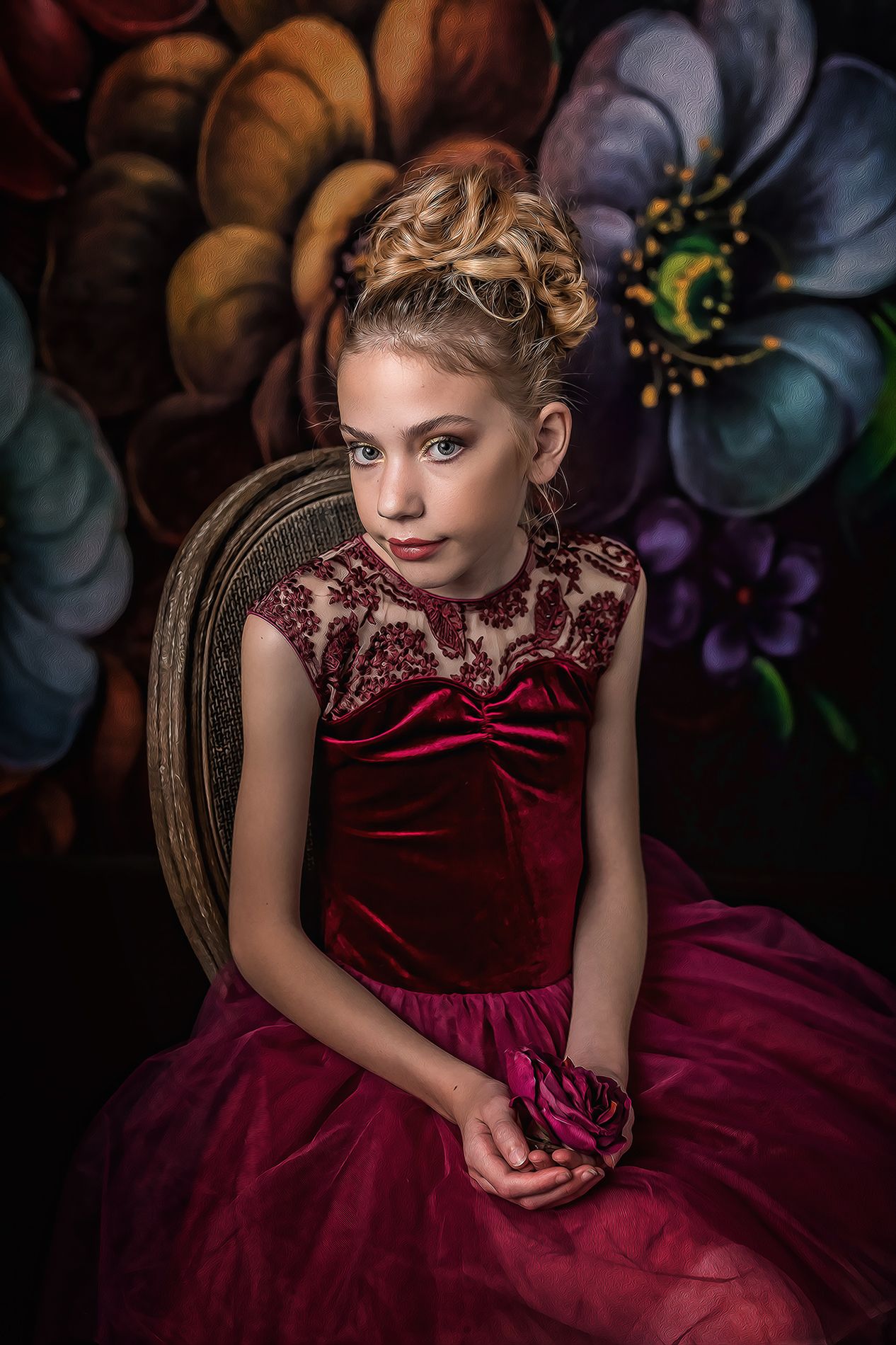 Young girl wearing burgundy gown seated in studio fine art child portrait photographed by Austin children photographer
