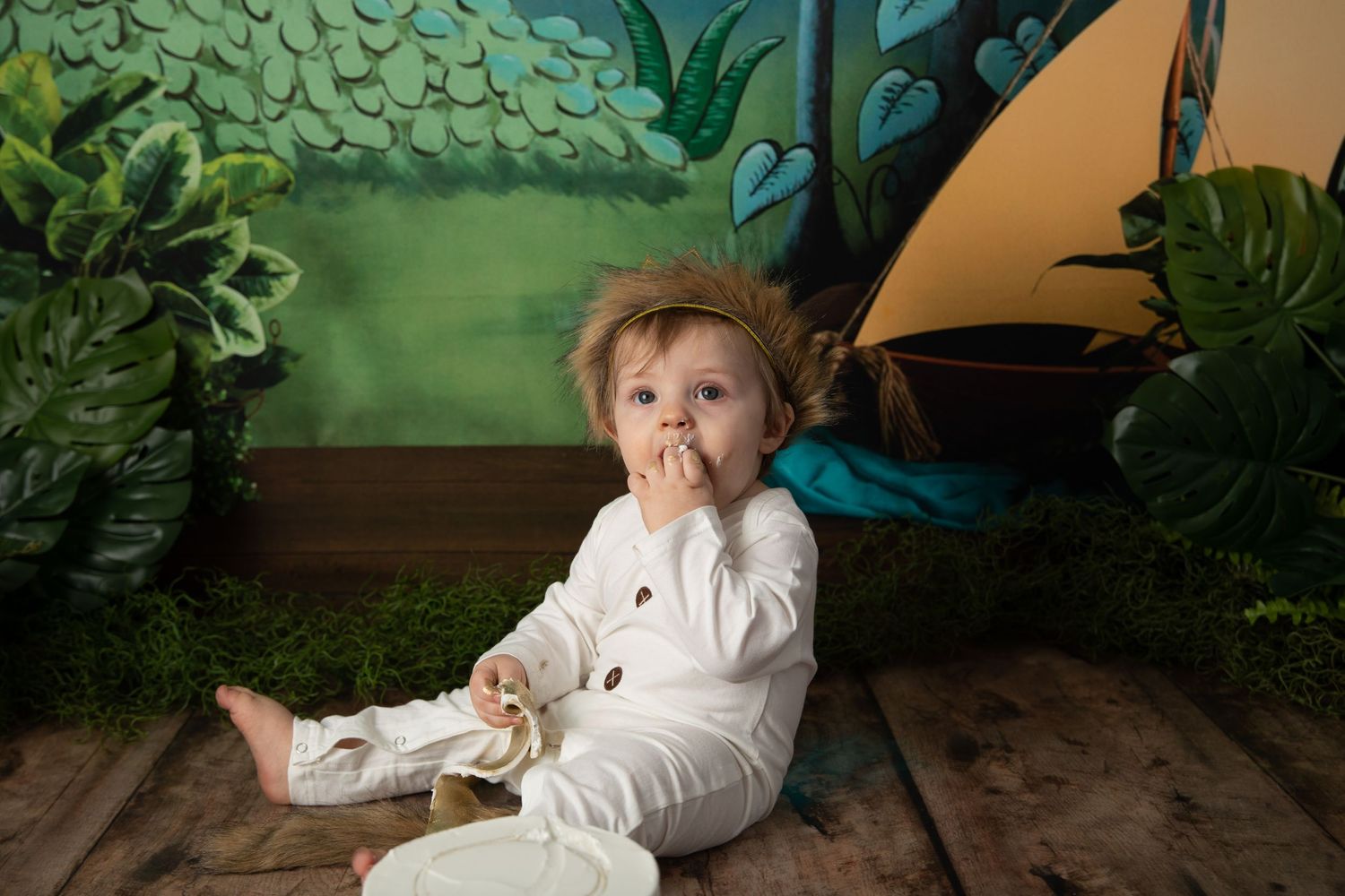 Whimsical children's portrait backdrop featuring painted palm trees and stars against a blue sky.
