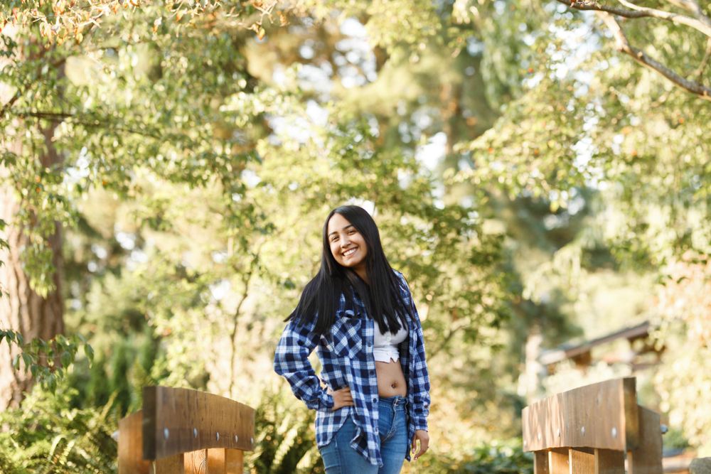 Everett Senior Photographer: A young lady stands on the wooden bridge at the Evergreen Arboretum in Everett WA