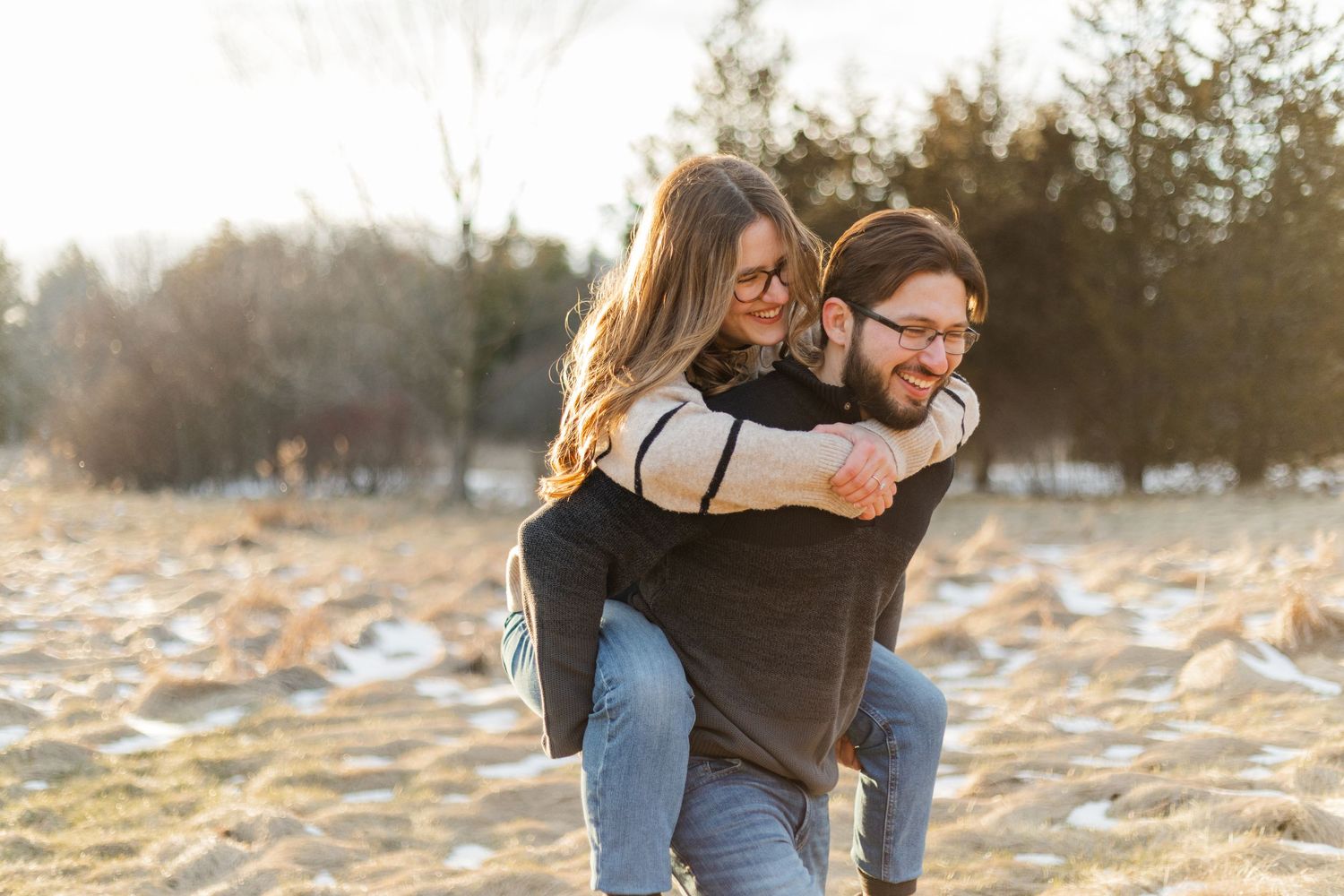 A romantic embrace captured during a winter photo session at sunset.