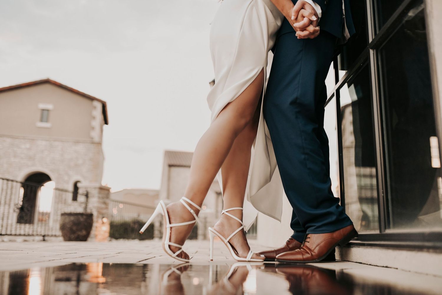 Engaged couple posing at sunset beside the water at Chapel at Palacios in North Texas