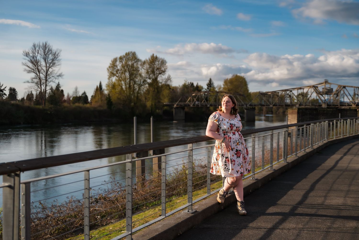girl smiles into the sunset in downtown mount vernon, wa while leaning on rail