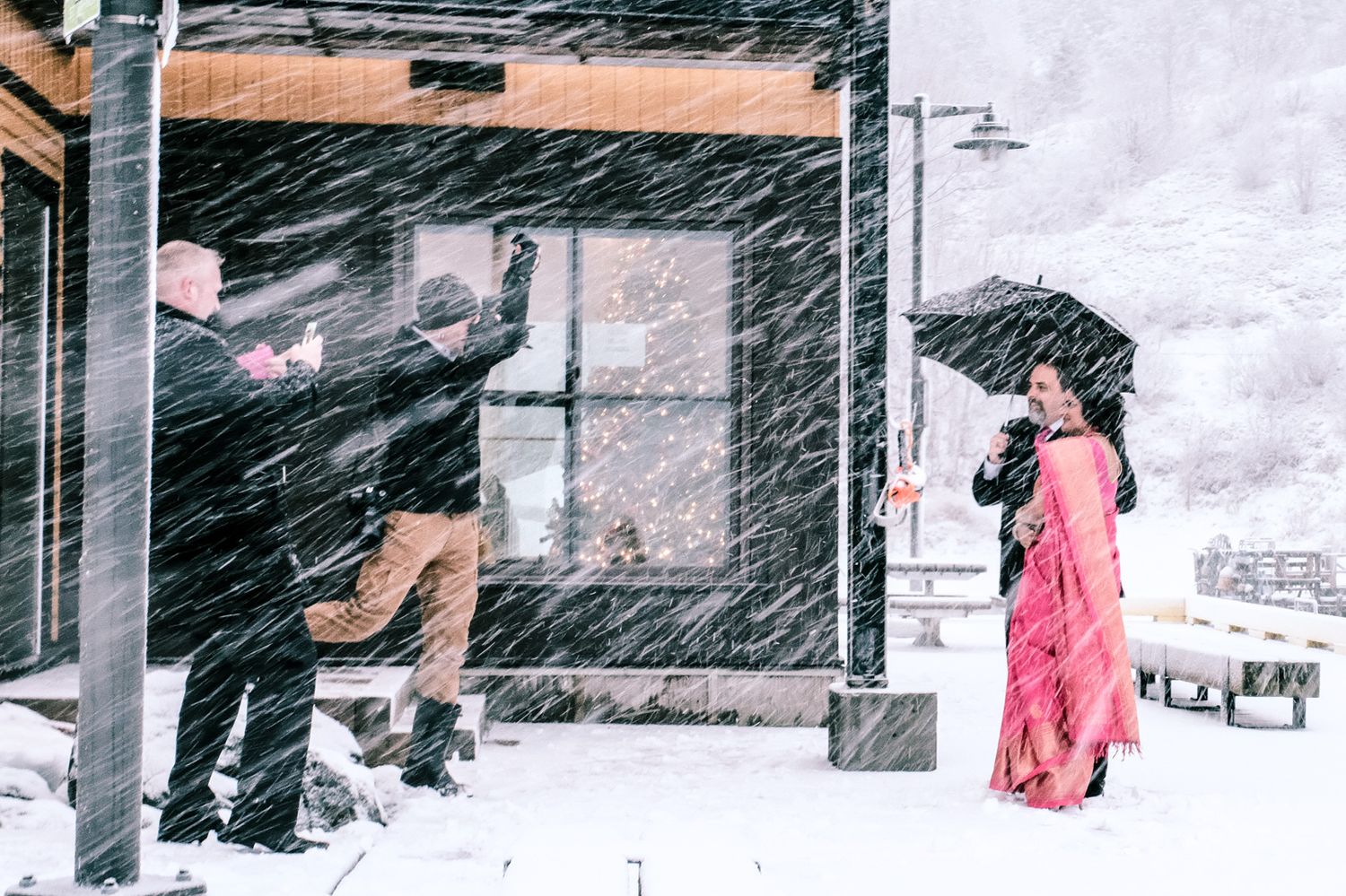 Wedding photo in a snowstorm at Quidi Vidi Village, Newfoundland, the unique moment amidst the Newfoundland weather.