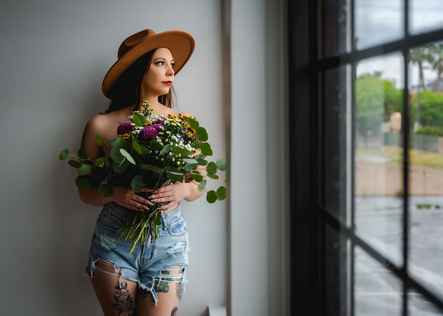 Celebrate natural beauty with bohemian boudoir; denim, wildflowers, and romantic charm for a self-love journey.