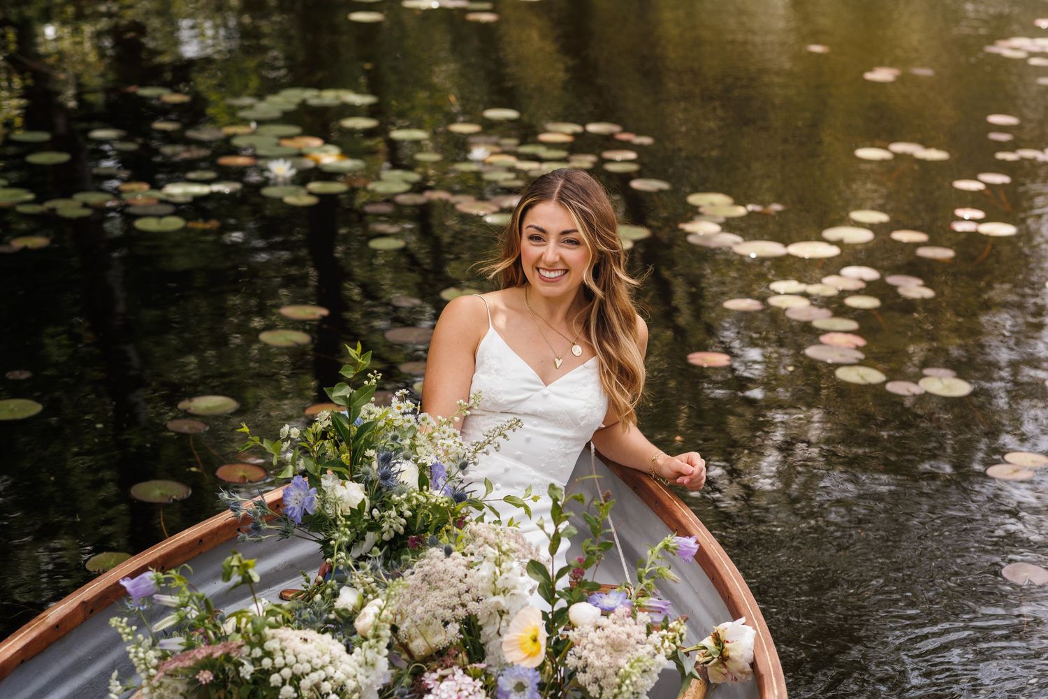 A wooden boat adorned with beautiful flowers floats on tranquil water.