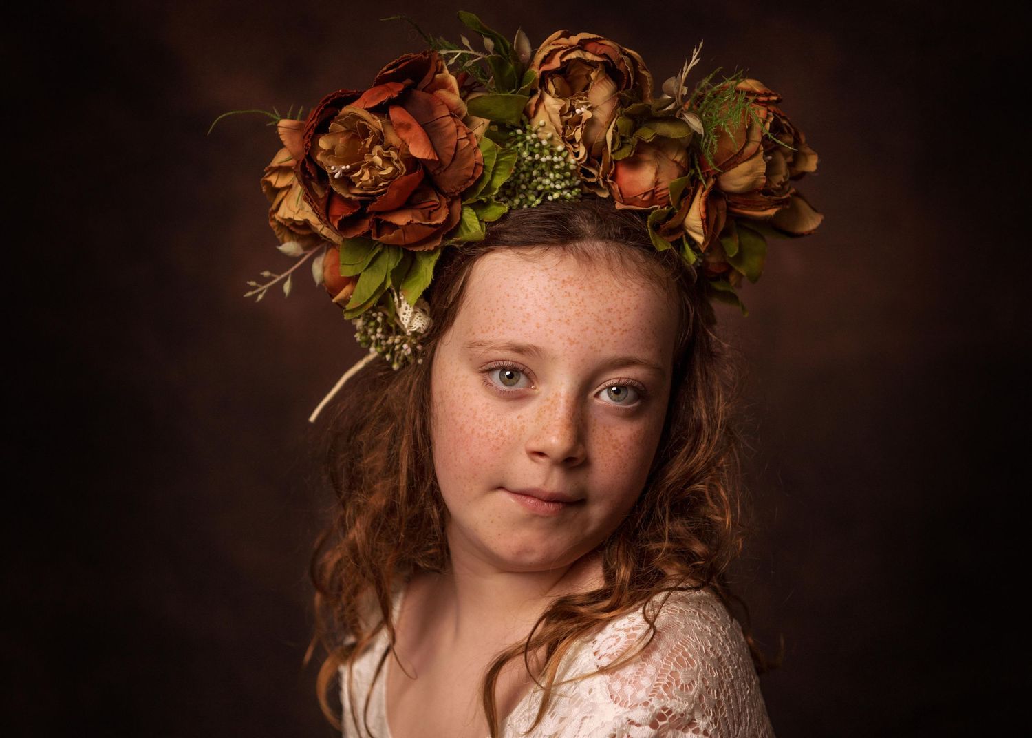 A portrait in Renaissance style featuring a floral crown of autumnal roses against a dark background.