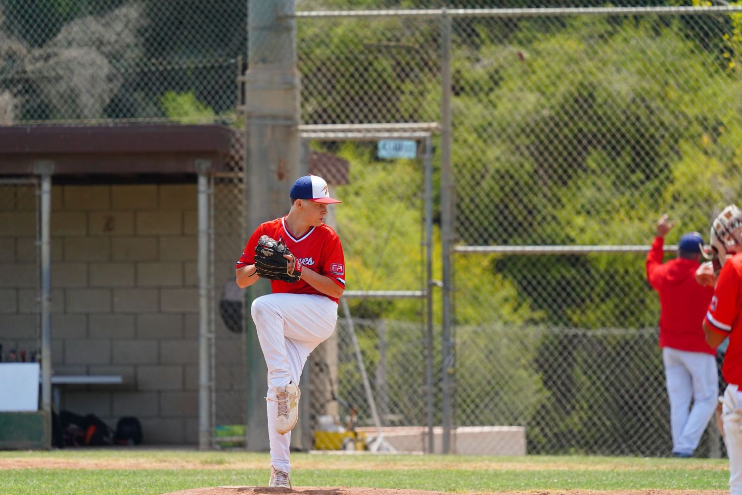 Ventura Braves pitcher delivers from the mound during a baseball game in Ventura County, California.