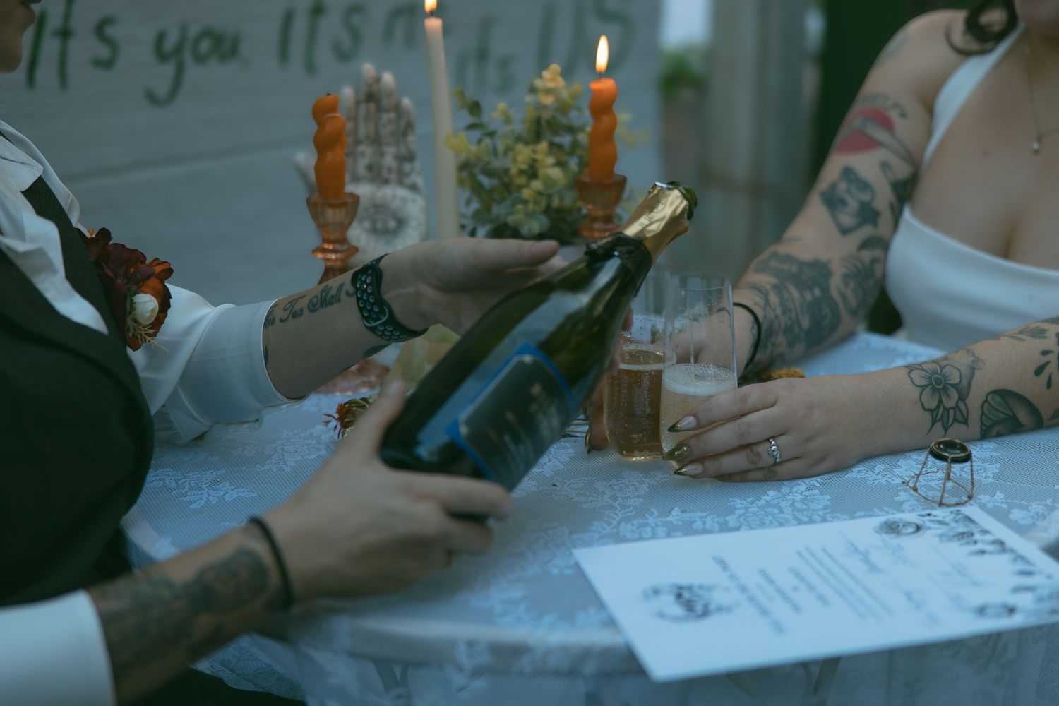 lesbian couple pouring biltmore champagne celebrating signing marriage license