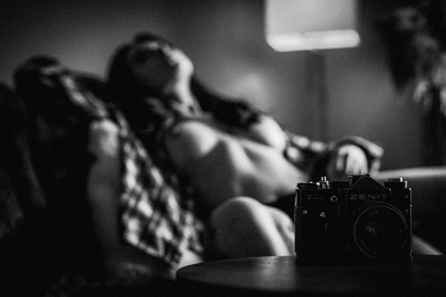 A series of black and white cinematic film stills showing intimate moments in low lighting.
