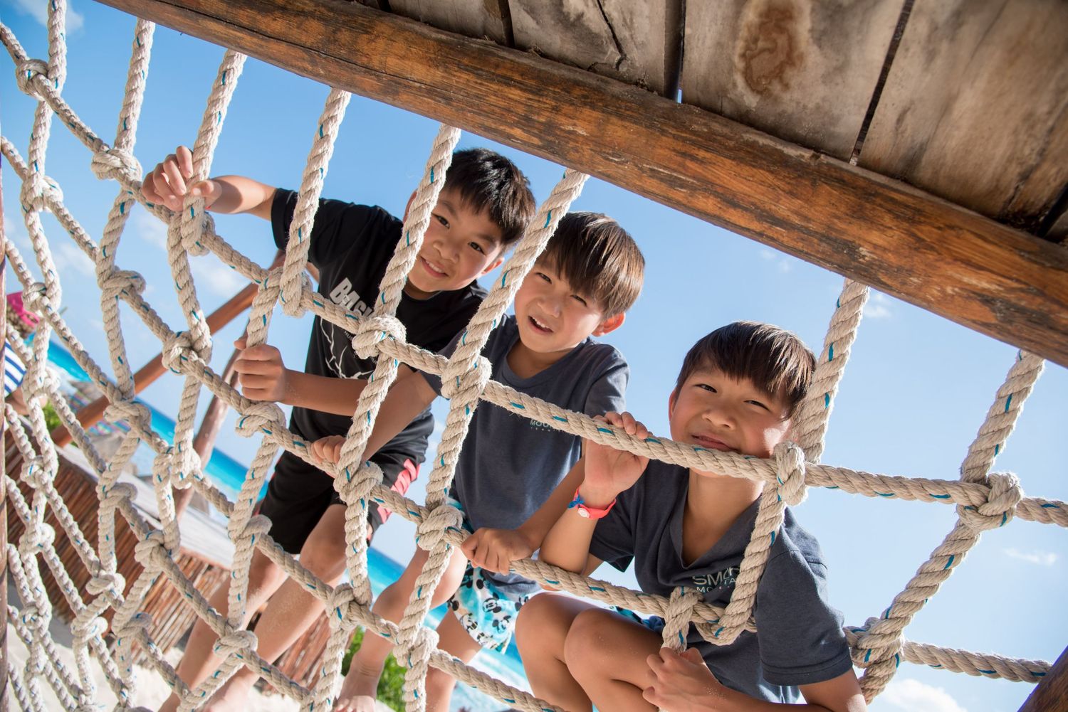 The children climbing ropes at the playground during the family photoshoot