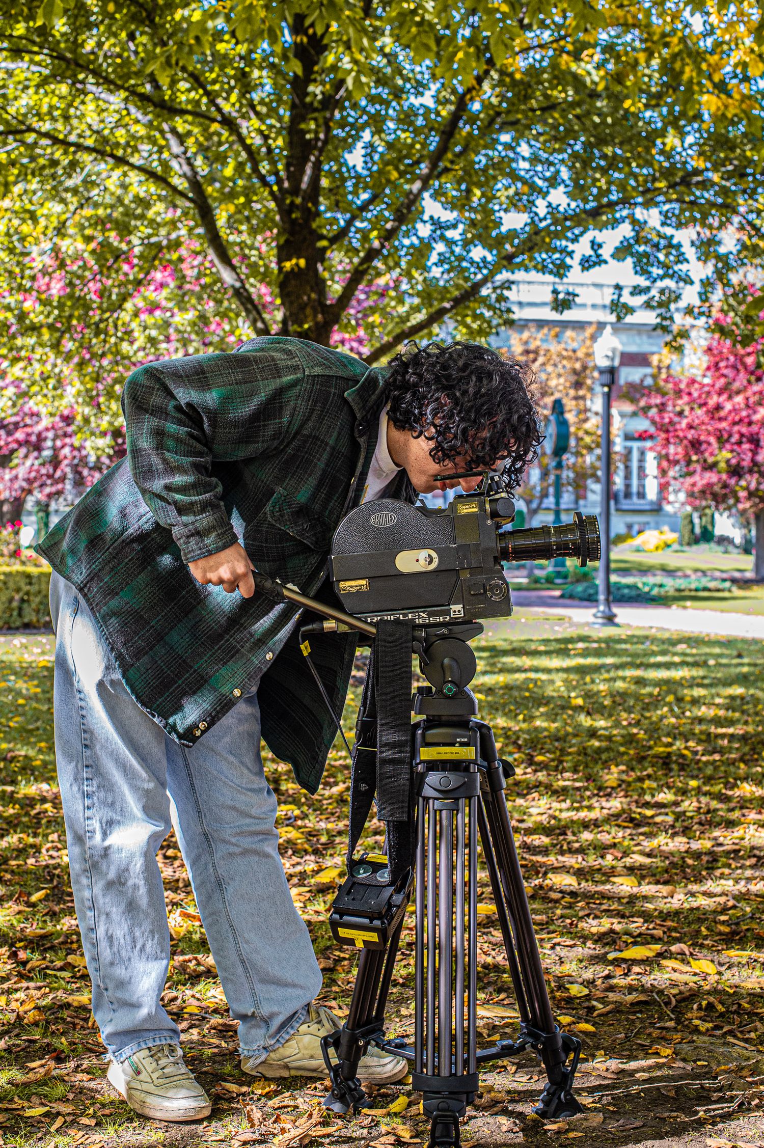 Emerson College student filmmaker Mario Monj looks through viewfinder of Arriflex 16R 16mm motion picture film camera