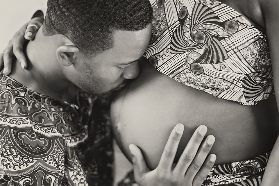 Black and white series of intimate family moments on patterned fabric.