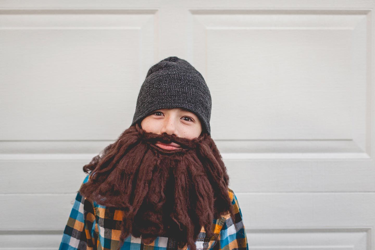 Boy dressed up as a lumber jack with a big beard for Halloween