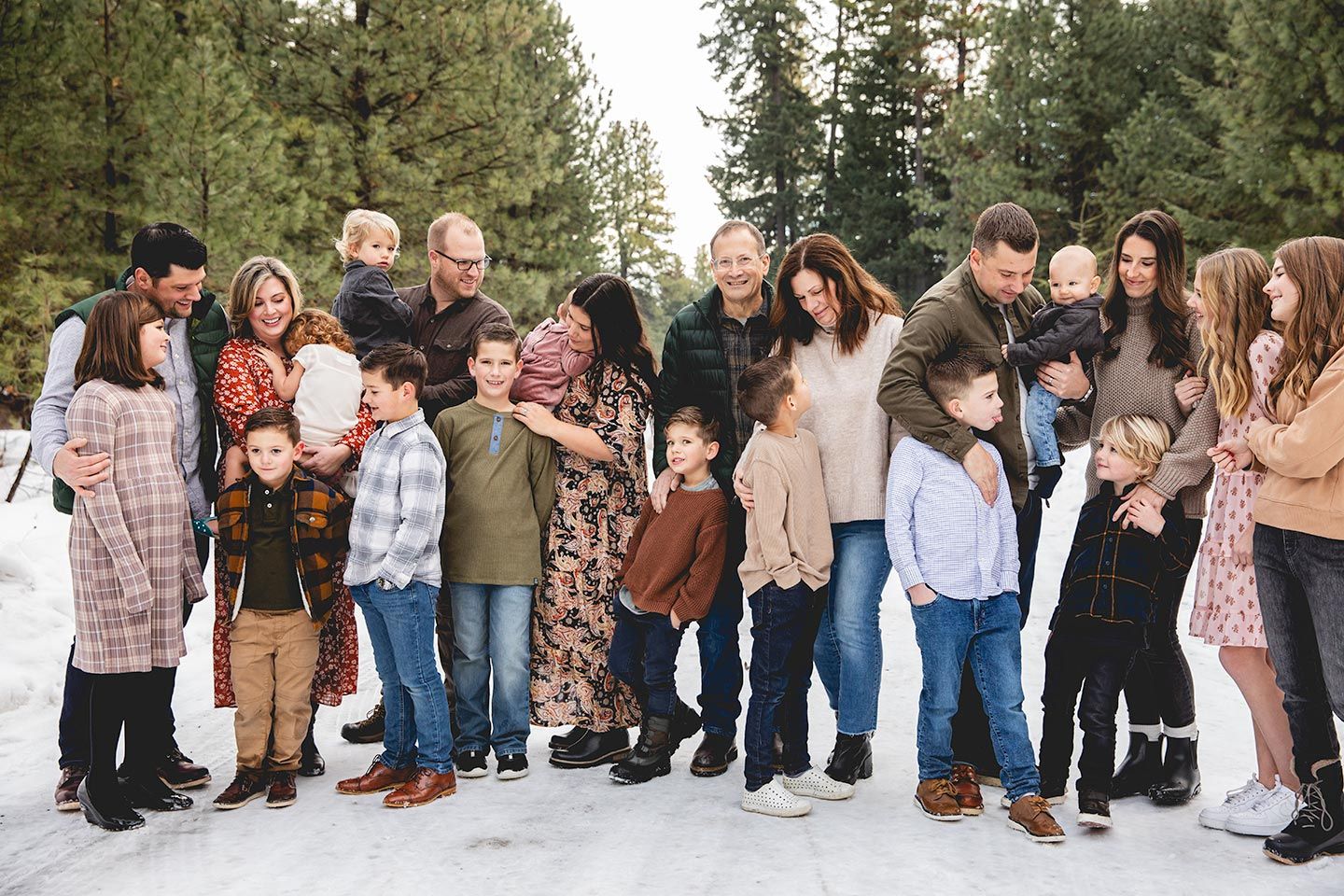 large extended family standing together and looking at each other with smiles and silly faces