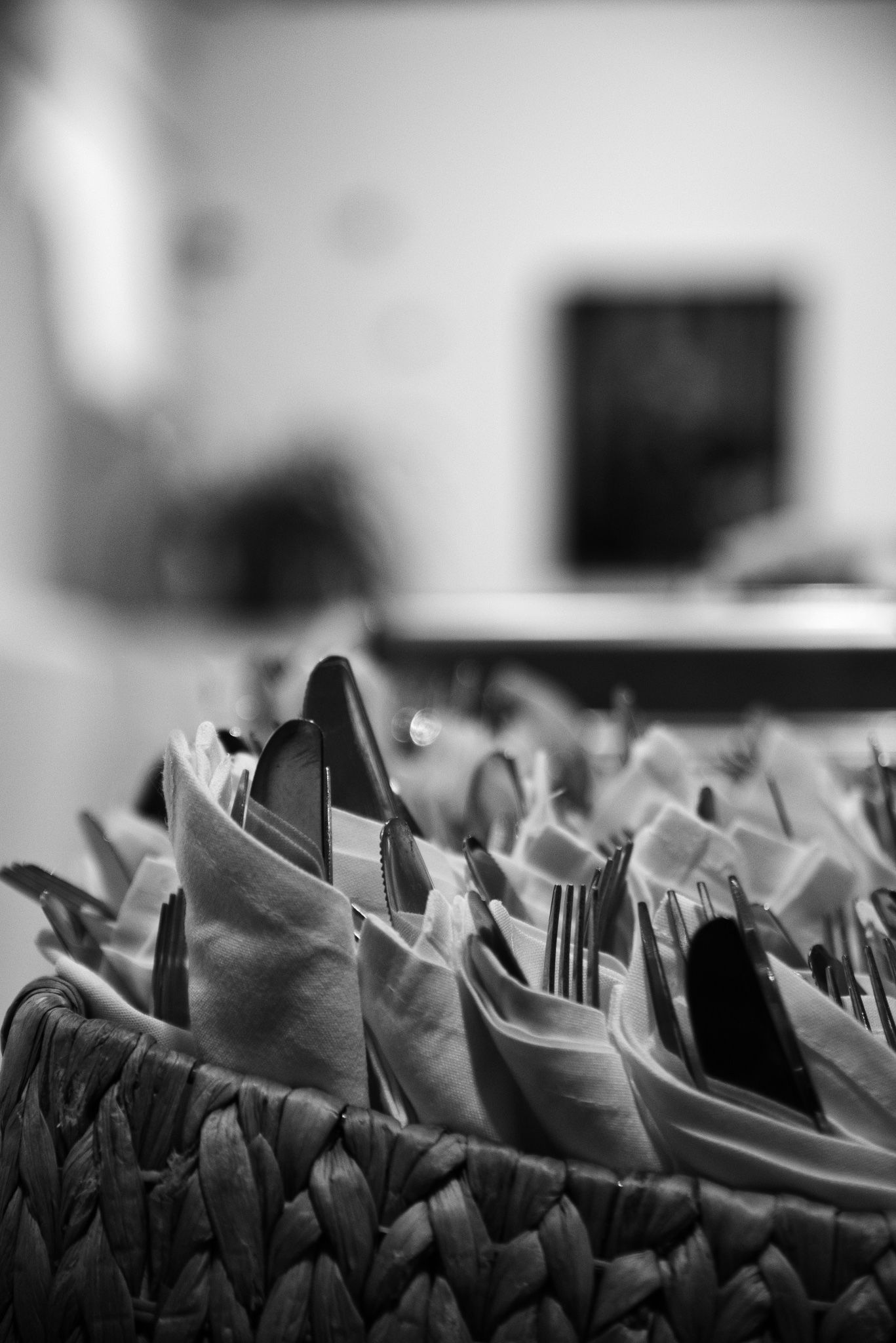 black and white close up of silverware place settings