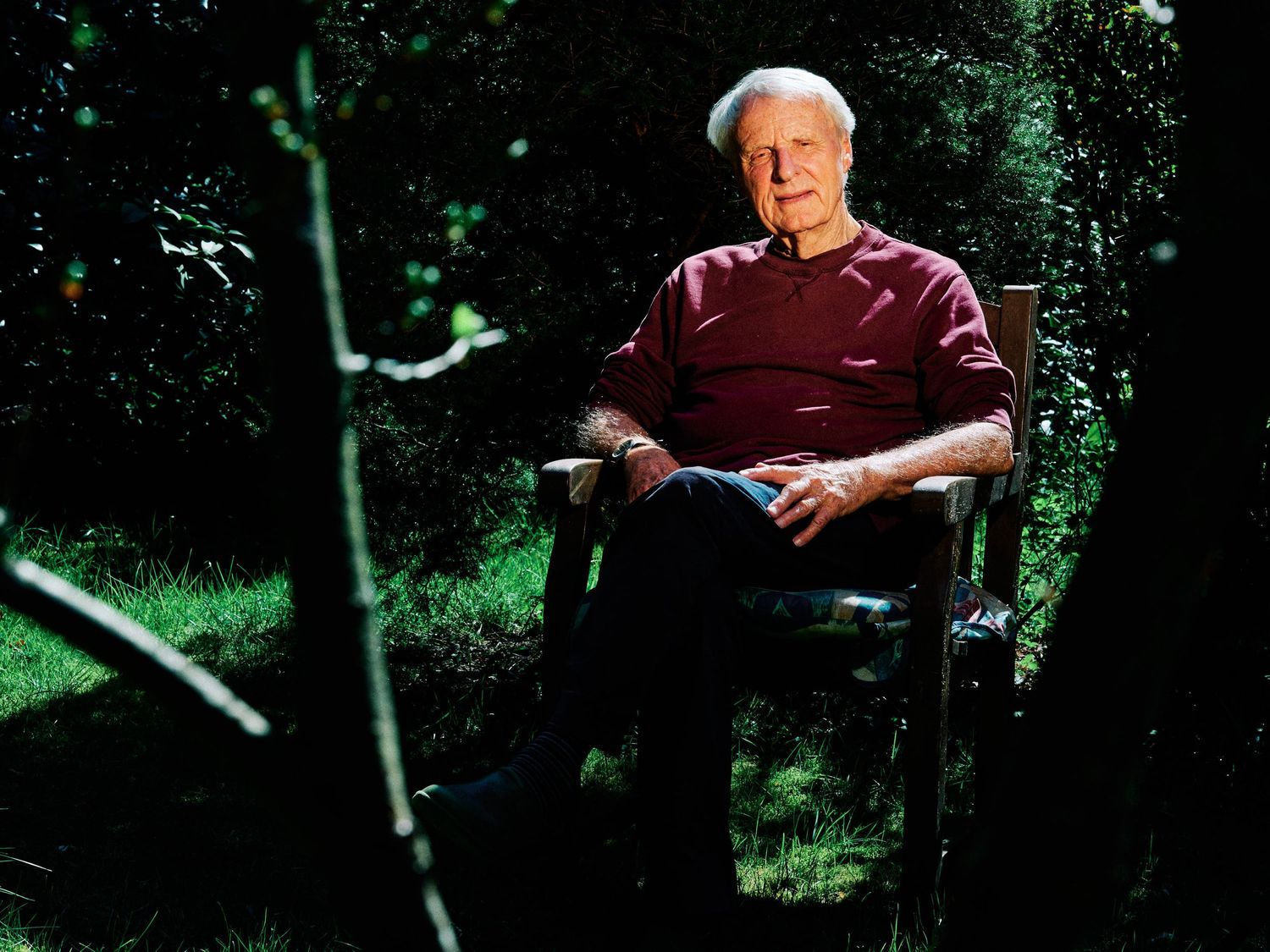 Jørgen Løvgret sitting in his chair in the garden