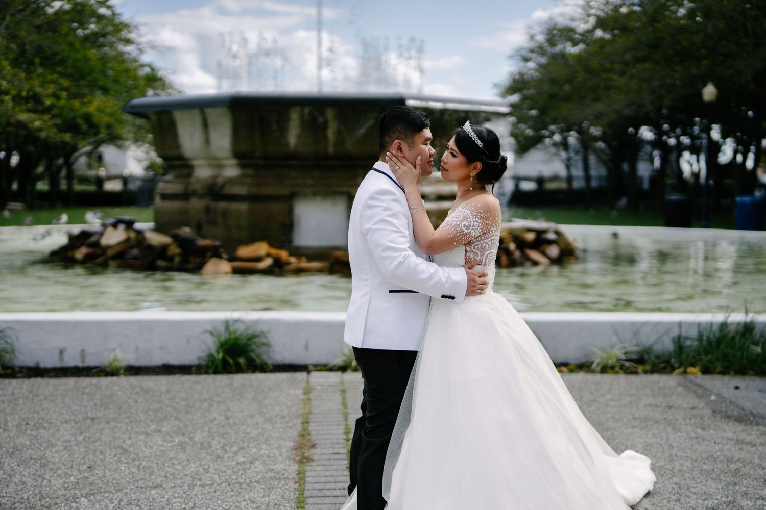 Wedding couple sharing romantic moments in an outdoor garden setting.